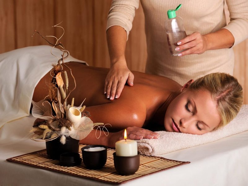 Integrated massage with oil applied to a client’s back