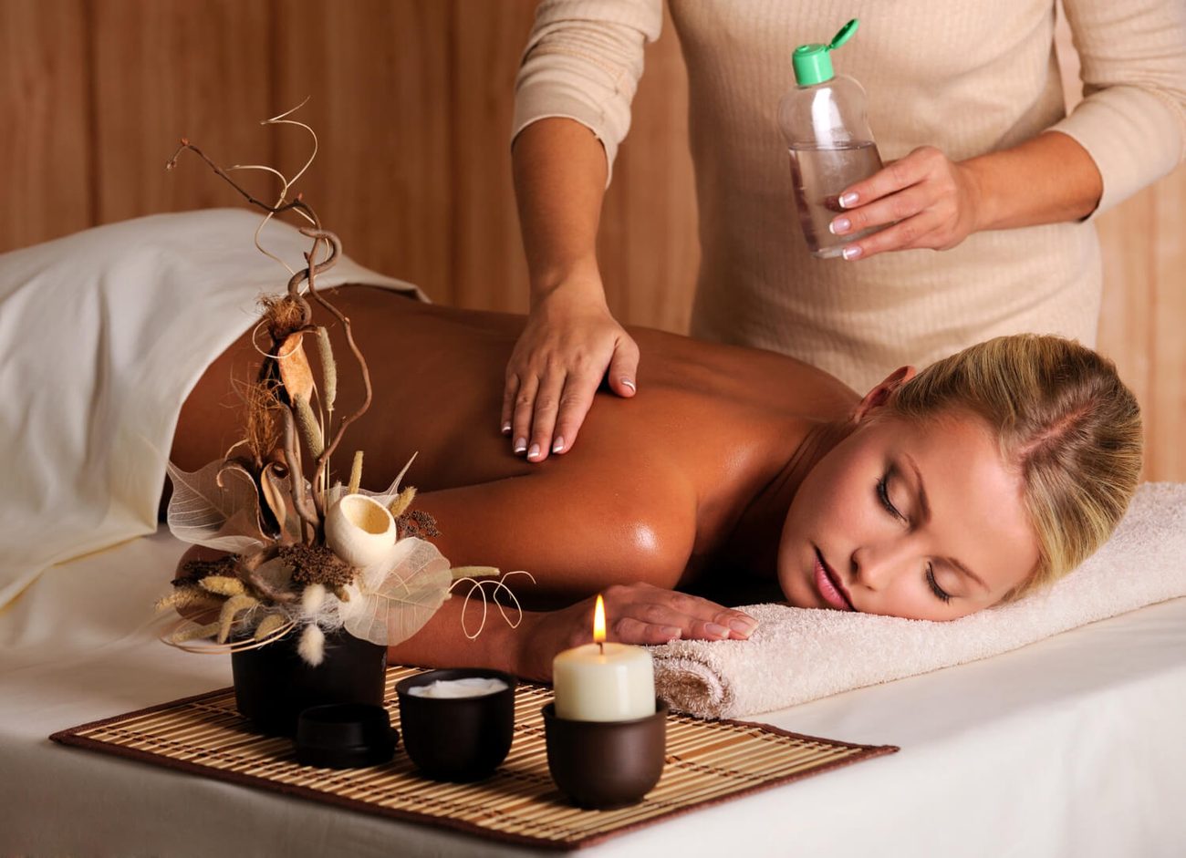 Massage therapist applying oil during an integrated massage session
